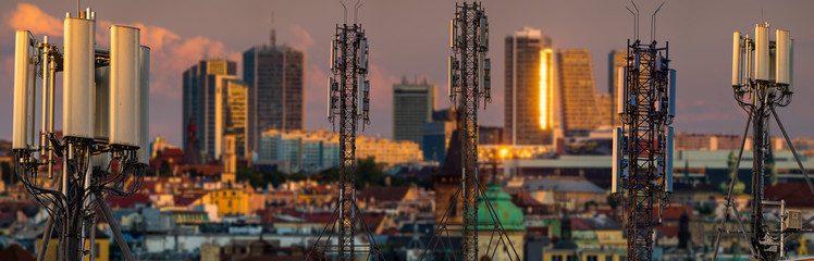 GSM antennas on the masts against the background of the city