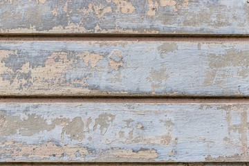 Gray, beige old wall with peeling plaster