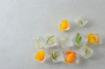 Floral ice cubes on the gray background.