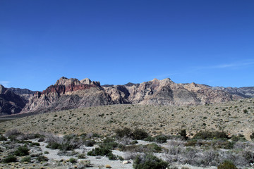desert has red rock wrapped mountain