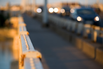Handrail on the bridge and traffic out of focus,