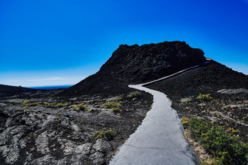 Fototapeta na wymiar Splatter Cone with hiking path at Craters of the Moon National Park.