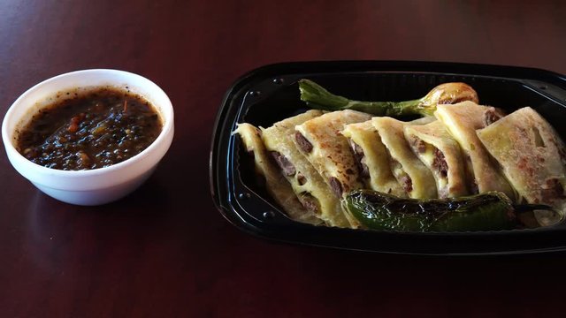row of beans, quesadillas with meat and sauce ready to taste