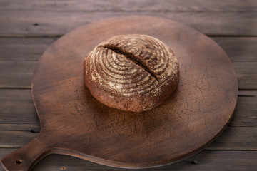 Fototapeta na wymiar Bread bun round on a wooden background
