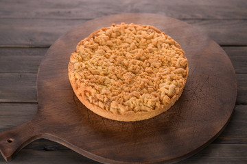 pie with cheese round on a wooden background