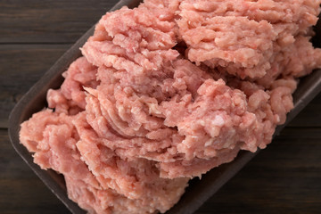 minced chicken in a tray on a wooden background