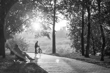 Sunset silhouette of man with bicycle