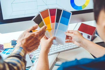 Graphic designer Brainstorming Meeting and drawing on graphics tablet at workplace