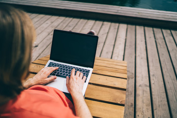 Man surfing on laptop on sunbed
