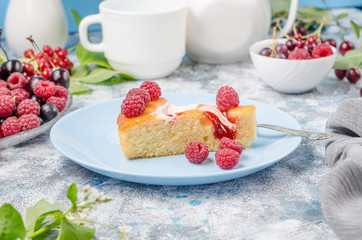Sponge cake with raspberries on a blue background