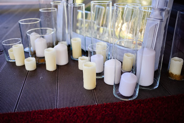 Beautiful candles in glass transparent vases.
