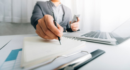 Digital marketing media in virtual screen.businesswoman hand working with mobile phone and modern compute with VR icon diagram at office in morning light