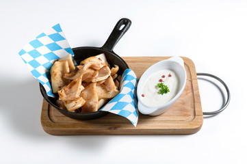 ears of a pig on the grill in a frying pan