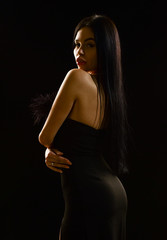 Fototapeta premium Aesthetics female beauty. Mystery concept. Mysterious fashion model. Sexy girl in darkness. Nude shoulders. Girl with long hair. Impeccable appearance. Mysterious fashion lady. Attractive woman