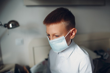 Fototapeta na wymiar Little boy dressing uniform and medical mask preparation back to school.