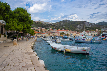 Hvar/Croatia-August 4th,2020: Beautiful Hvar city with old fortress towering above the town, overlooking the bay and port crowded with ships and boats