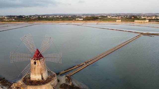 Windmill And Saline Near The  Town Mazara del Vallo In The Province Of Trapani, Southwestern Sicily, Italy. - aerial drone