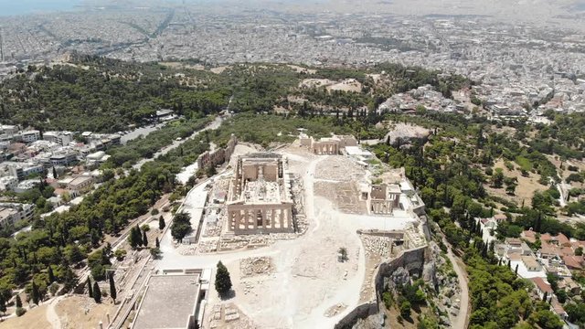 Flying above Acropolis of Athens Greece with close up view of the Parthenon temple.