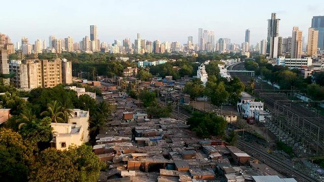 Drone Shot showing Mumbai Slums with City in the Background