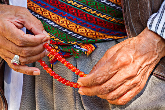 Worry beads in hands.