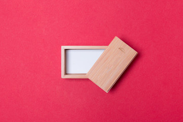 open wooden box with place for you logo on red colored paper background
