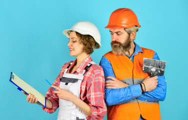 real estate deal. talk about interior decoration. under construction. looking at construction house plan. how new home is being built. Worker show house design. couple discussing blueprint at home