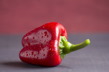 Closeup shot of red pepper with droplets of water on it