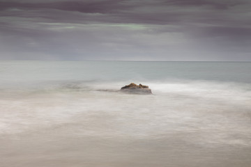 Fototapeta na wymiar Waves and rocks in a Spanish beach
