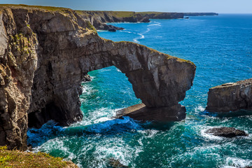 Naklejka premium The Green Bridge of Wales coastal feature on the Pembrokeshire coastal path, Wales in summer