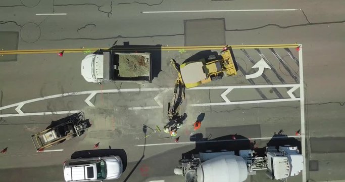 Road Workers repairing the street with tractor equipment