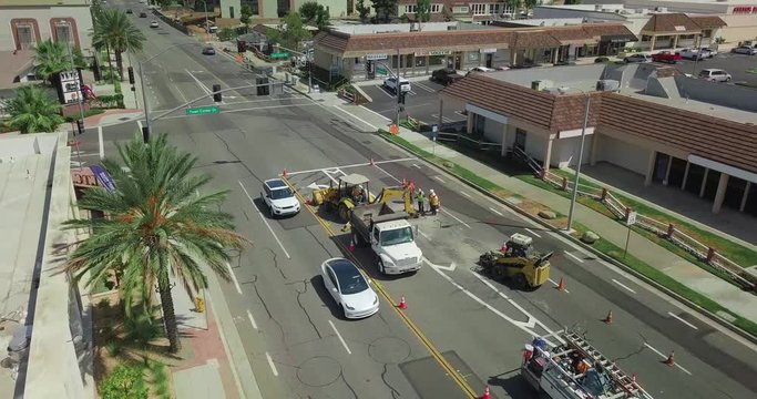 Road Workers repairing the street with tractor equipment