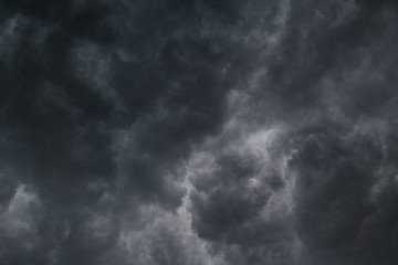 Obraz premium Dramatic black rain clouds before a massive storm. Tropical storm, tornadoes, thunder, lightning, hurricane background