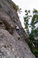 Close up of rock climber tying knot. Mountain climbing training