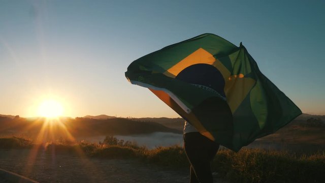 Girl hugged with Brazilian flag on Independence Day