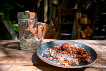 drink beer and leftover crayfish on a plate that someone has already eaten