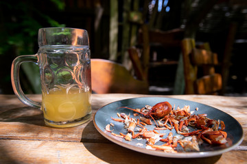 Beer and leftover crayfish on a plate that someone has already eaten