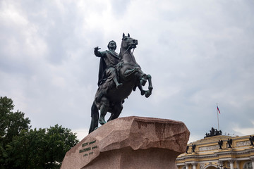 Bronze horseman monument on Neva river embankment on cloudy day. Unique urban landscape center Saint Petersburg. Central historical sights city. Top tourist places in Russia. Capital Russian Empire