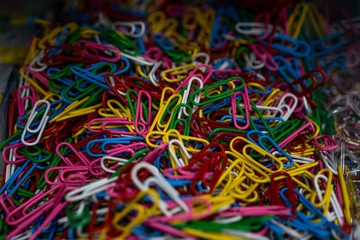 Colorful paper clips background. Macro close-up. Selected focus