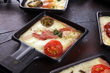 Delicious traditional Swiss melted raclette cheese on diced boiled or baked potato.