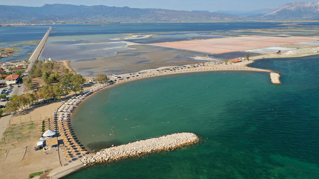 Aerial drone photo of organised sandy beach in area Tourlida of Kleisova lagoon featuring seaside traditional settlement, Mesolongi, Aitoloakarnania, Greece