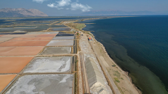Aerial drone photo of artificial sea salt ponds in area Tourlida of Kleisova lagoon featuring seaside traditional settlement, Mesolongi, Aitoloakarnania, Greece