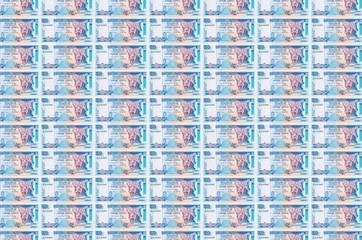 50 Sri Lankan rupees bills printed in money production conveyor. Collage of many bills. Concept of...