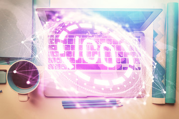 Blockchain theme hologram drawings over computer on the desktop background. Top view. Multi exposure. Concept of cryptoeconomy.