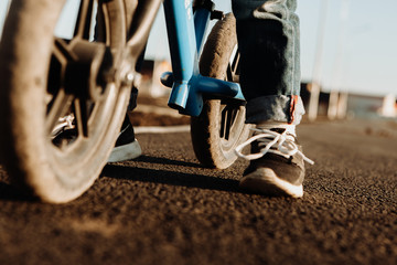 Naklejka premium A boy rides a balancing bike. Active walk
