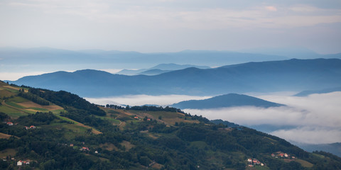 Landscape view on mountains, hills and meadow, village in Tara national park in Serbia