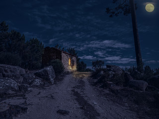 A beautiful house made of stone at night with full moon, Sintra, Portugal