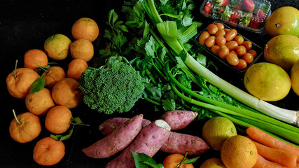 A small variety of fruits and vegetables that have just arrived from the organic fair.