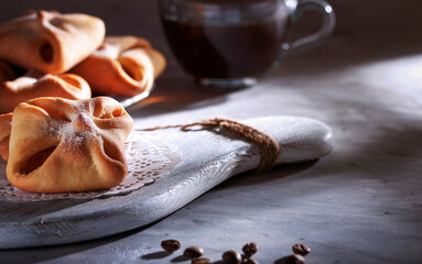 Homemade sweet pastries for coffee..Fresh delicious pastries on the table served with coffee. The light from the window falls on the table.