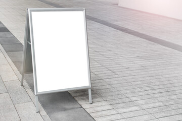 Mockup template of empty blank standee billboard stand on the background of pavement.