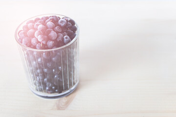 Close up of glass full of blueberries great source of antioxidants. Photo with color tint and copy blank space.